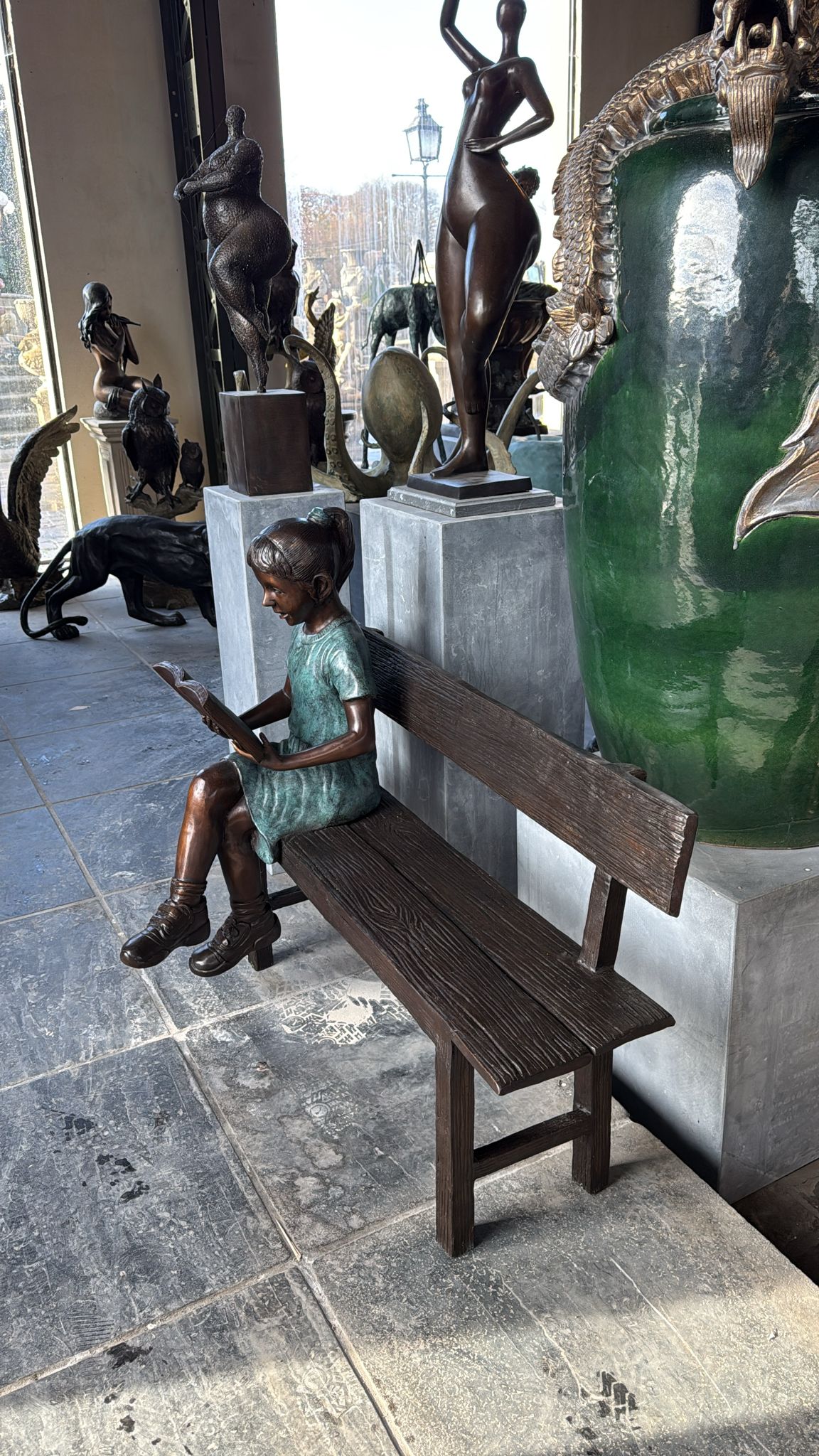 Reading girl on bench bronze 111cm