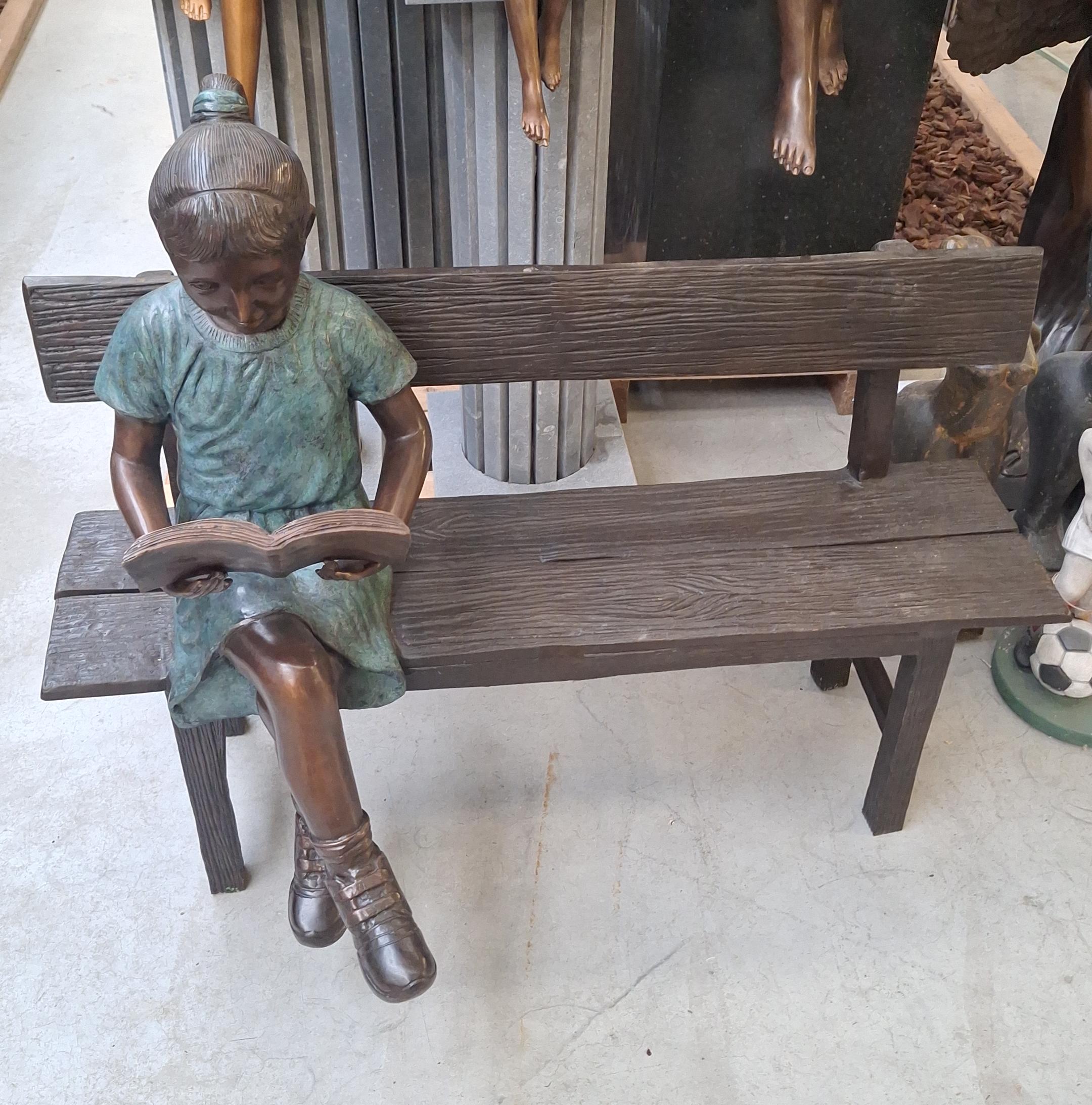 Reading girl on bench bronze 111cm